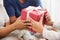 Asian boy giving a red gift box to Grandfather and Grandmother.