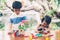 Asian boy and gril playing wooden block toy on table for creative and development with enjoy.