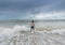 An Asian boy has felt happy and fun on the beach with a cloudy sky