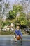 Asian boy holding a basketball ball Background blurry trees