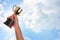 Asian boy holding a gold trophy cup for first place champion award on white background.