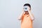 Asian boy joking gesture wearing fake glasses made with iron dumbbell