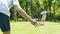 Asian boy kicking soccer toward his father as goal keeper outdoors in summer in slow motion