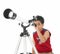 Asian boy looking through a telescope