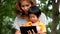 An Asian boy and mother are playing funny game on tablet.