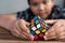 Asian boy playing with rubik`s cube.boy solving puzzle