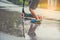 asian boy playing scooter on wet ground .