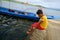 Asian boy playing water with foot on public ancient old vihara hall temple( (Underwater temple).