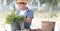 Asian boy prepare black soil to little plant on in the garden.