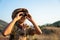 Asian Boy Scouts exploring nature with binoculars in camp on the mountain. landscape survey concept