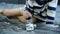 Asian boy sits and puts coins in a glass jar to save money to buy toys