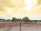 Asian boy stand alone in the demolition wasteland construction area at the sunset time with raylight and cloudy.