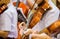 Asian boy students playing violin with music notation in the group. Violin player. Violinist hands playing violin orchestra