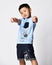 Asian boy in summer t-shirt and shorts squatting isolated studio shot