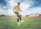 Asian boy teenager playing football at the stadium, sports, outdoor activities