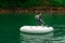 Asian boy wearing life jackets paddling on an inflatable boat in Kenyir Lake, Malaysia