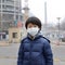 Asian boy wearing mouth mask against air pollution