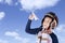 Asian boy wearing vintage flight helmet holding a plane paper