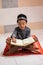 Asian boy who learns to read Al-Qur`an