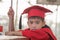 Asian boys face frowning Red graduation gown