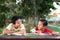 Asian boys laughing each other having fun time together at park in the evening