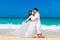 Asian bride and groom on a tropical beach. Wedding and honeymoon