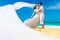 Asian bride and groom on a tropical beach. Wedding and honeymoon