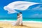 Asian bride and groom on a tropical beach. Wedding and honeymoon