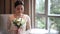 Asian bride in lace dress holding and smell beautiful white wedding flowers