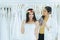 Asian bride trying on wedding dress,Woman designer making adjustment in fashion studio