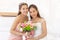 Asian brides in a white wedding dress and bridesmaids in a pink dress holding a bouquet of roses together and smiling brightly