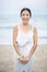 Asian bridesmaid standing at the beach