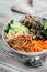 Asian buddha bowl on concrete table background. Delicious food concept