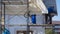 Asian builder workers with work tools on scaffolding are working to renovate external structure of the old house building,