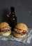 Asian burger with hoisin ketchup and chili mayo and beer on a gray background. Asian style