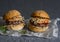 Asian burger with hoisin ketchup and chili mayo on a gray background. Asian style