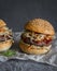 Asian burger with hoisin ketchup and chili mayo on a gray background. Asian style