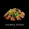 Asian burned salmon slices salad isolated on black background ready food banner with text space