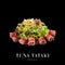 Asian burned tuna slices salad isolated on black background ready food banner with text space