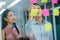 Asian business colleagues using sticky notes on window