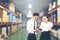 Asian Business man and Business woman worker in warehouse using