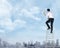 Asian business man standing on the ladder, holding megaphone