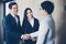 Asian Business people shaking hands and smiling their agreement