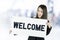 Asian business woman with long hair holding a welcome sign board.