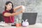 Asian business woman stretching arm, hand and finger to relaxing muscle at office desk