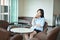 Asian business woman thinking in modern living room