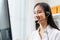 Asian business woman wear headset and working on telemarketing with online customer support.