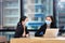 Asian business woman working together in co-working space following social distancing and new normal policy by wearing facial mask