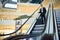 Asian Businessman Descending Escalator