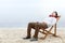 Asian businessman relax holding mobile phone while using headphones and lean back in the beach chair on beach